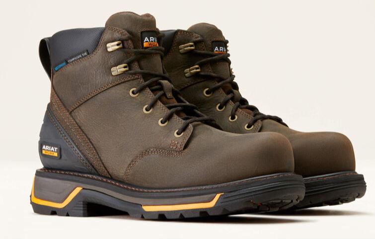 A pair of brown leather work boots with a lace-up closure, designed for men with wider feet and roomier openings. The boots feature a round toe and a thick, durable sole with yellow accents.