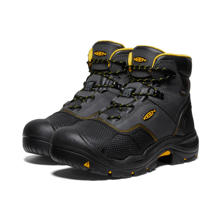 Pair of gray and black hiking boots with yellow accents on a white background