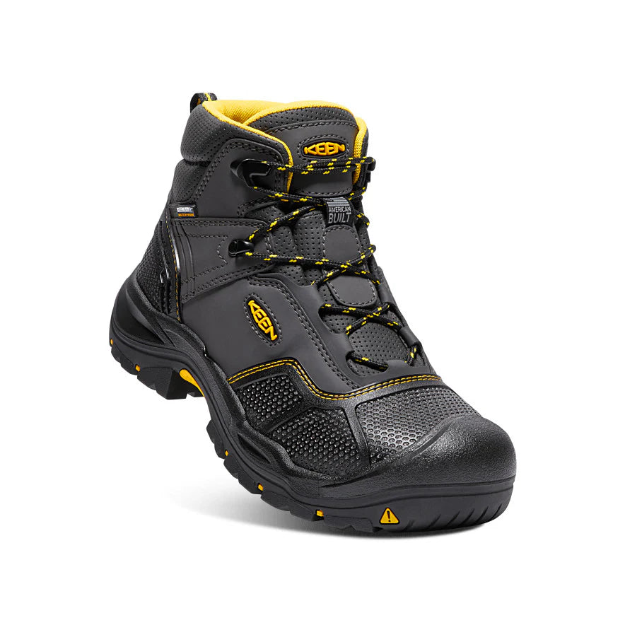 Gray and yellow work boot on a white background
