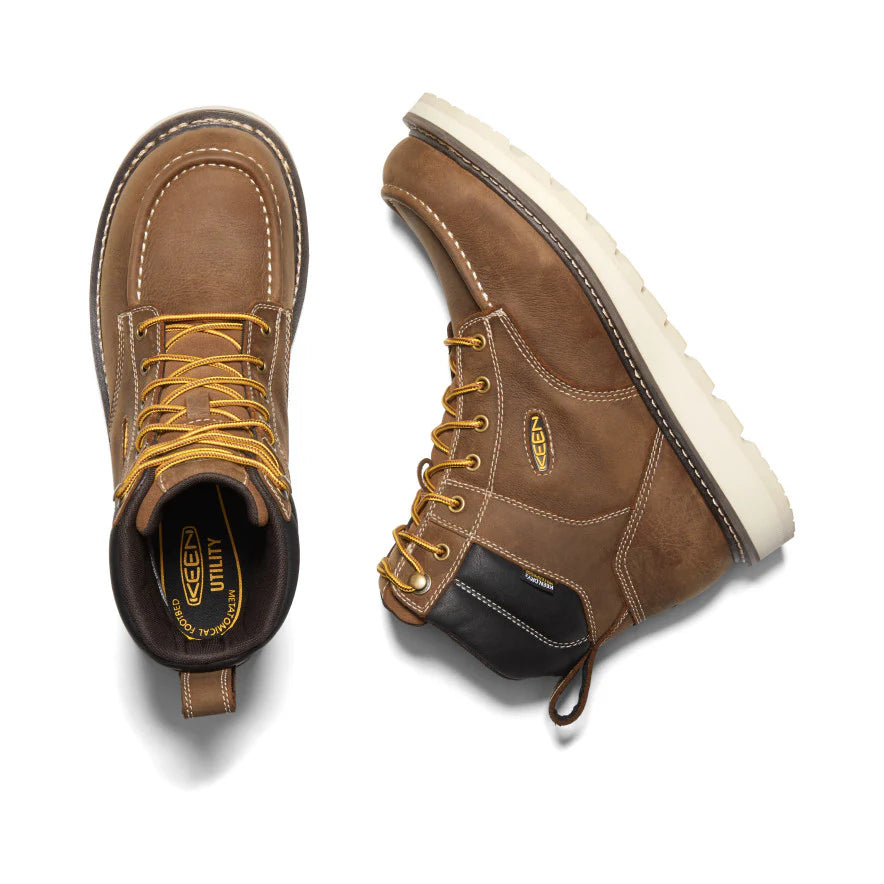 Pair of brown work boots with yellow laces on a white background
