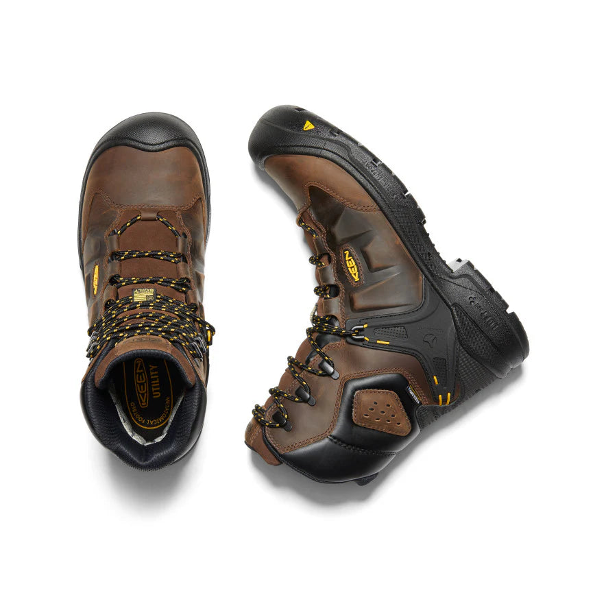 Pair of brown and black work boots on a white background