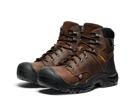 Pair of brown hiking boots with black soles on a white background