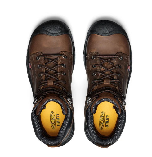 Pair of brown work boots with black soles on a white background
