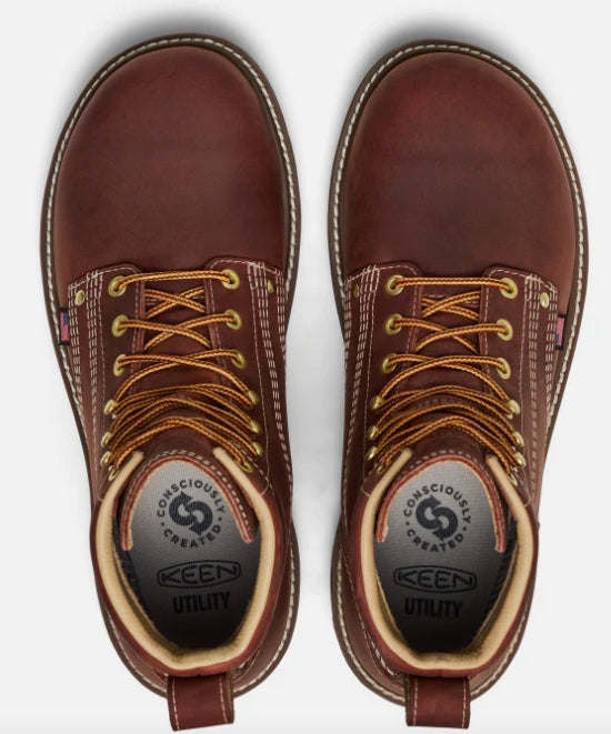 Pair of brown leather boots with laces on a white background