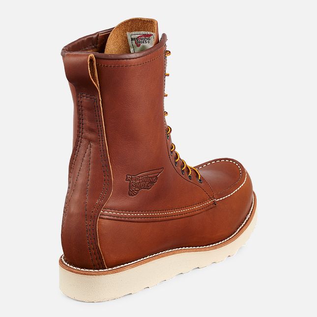 The back of a tall light brown boot with a white background. 