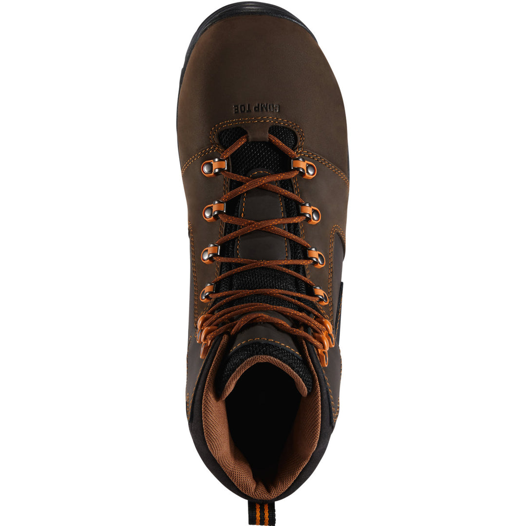 A top down view of a brown boot with orange laces with a white background. 