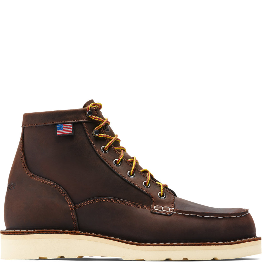 A brown full-grain leather men's boot with a steel toe, lace-up closure, and a Danner Wedge outsole. Features a non-waterproof liner and an American flag on the top.