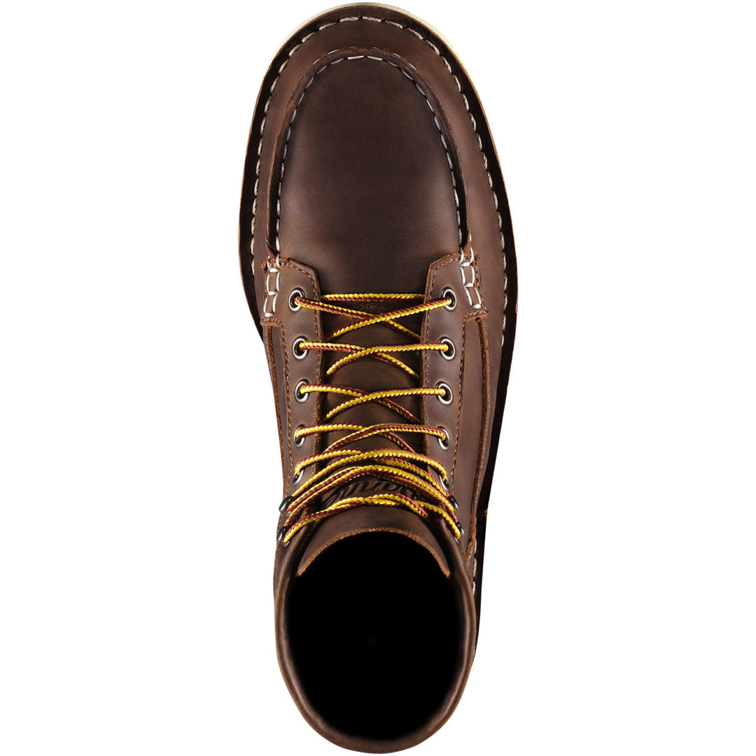 A top down view of a brown boot with yellow laces with a white background. 