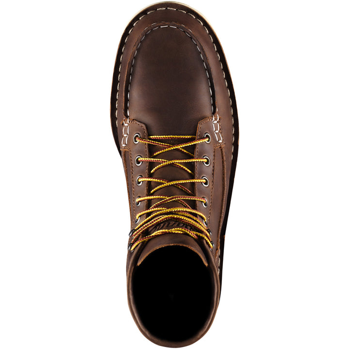 A top down view of a brown boot with yellow laces with a white background. 