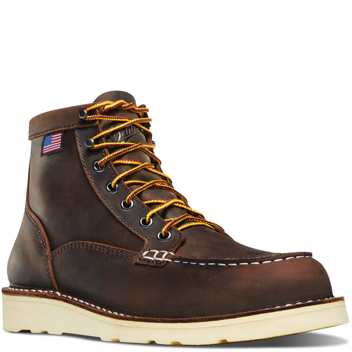 A women's brown Danner boot with a lace-up closure, featuring a round toe and a non-waterproof lining. The boot has white stitching and a small American flag on the side.