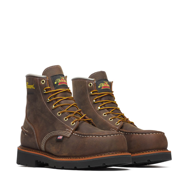 A pair of brown boots with yellow laces with a white background,