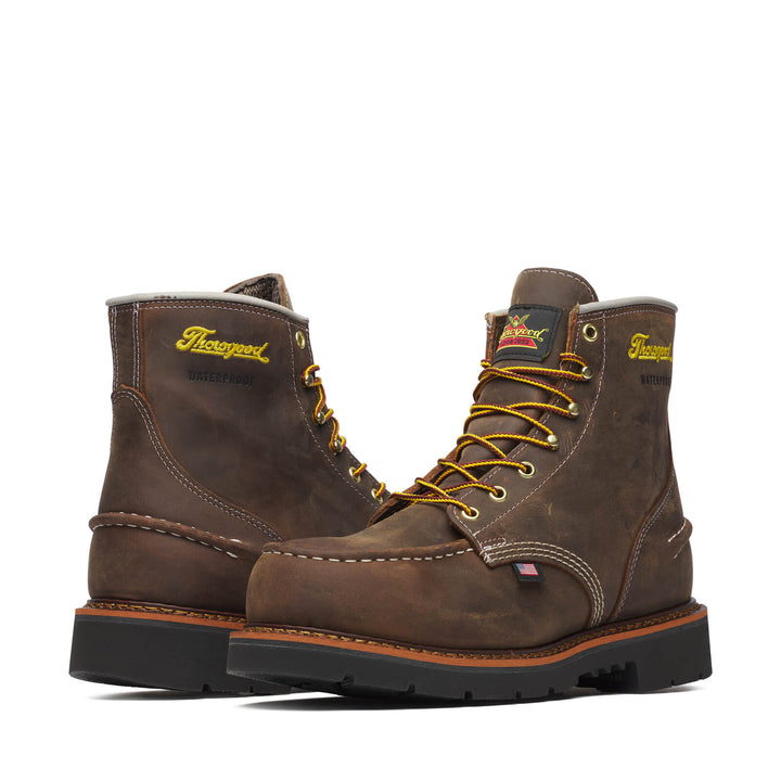 Two boots facing opposite directions with yellow laces on a white background. 