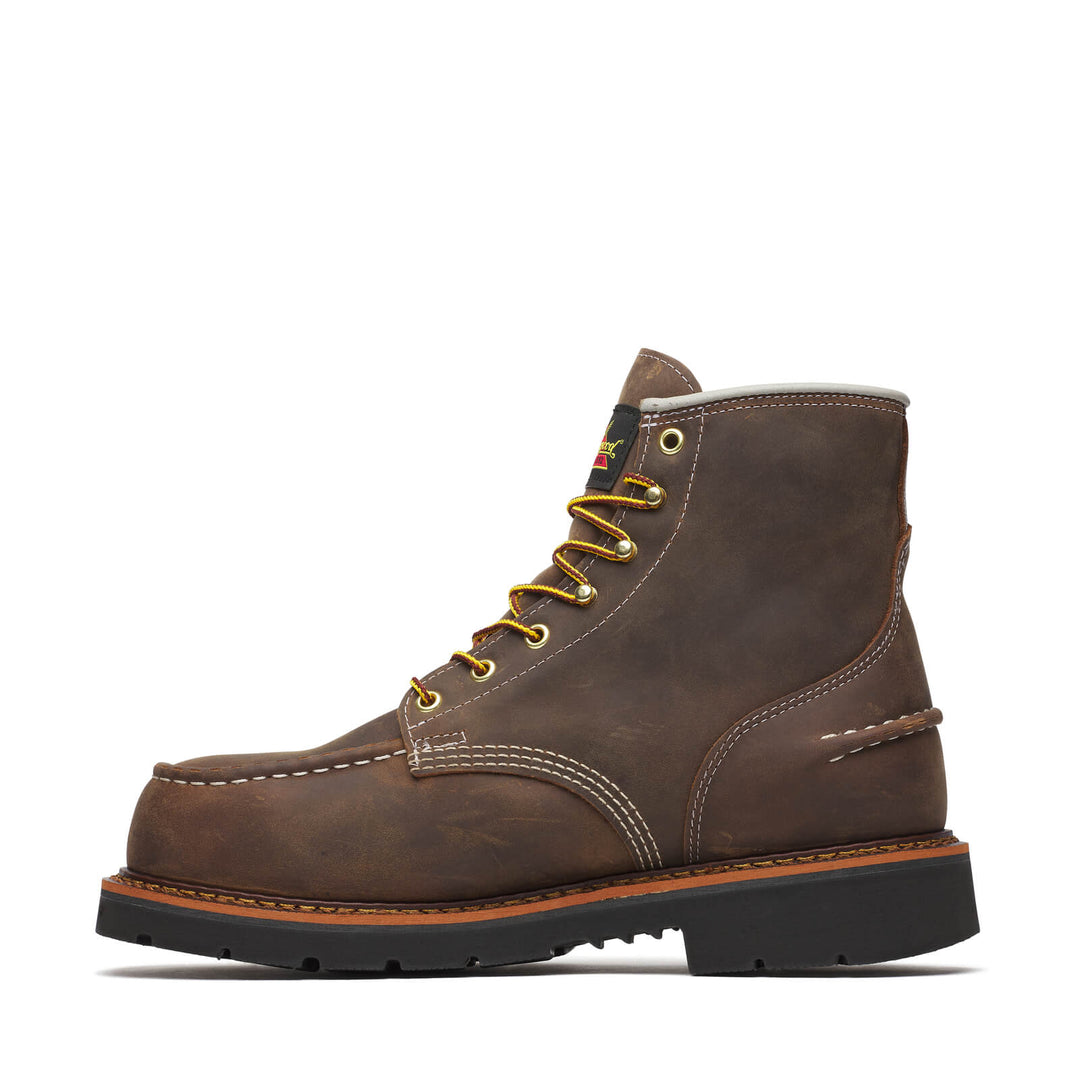 Side angle of a brown boot with yellow laces on a white background. 