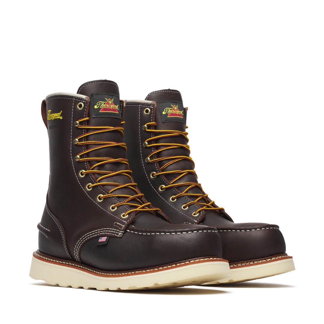 Pair of brown leather boots with yellow laces on a white background