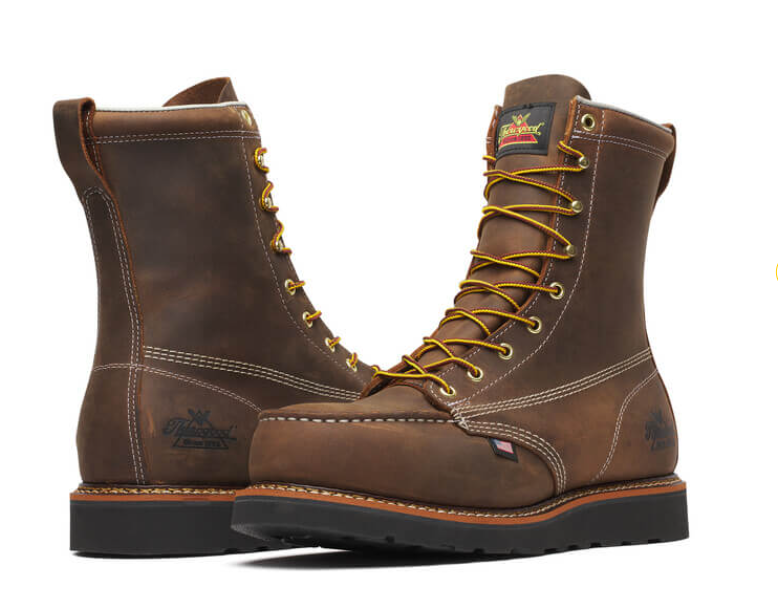 Pair of brown leather boots with yellow laces on a white background