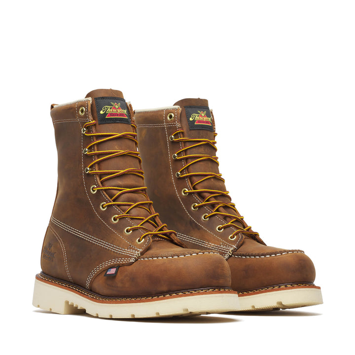 Pair of brown leather boots with yellow laces on a white background