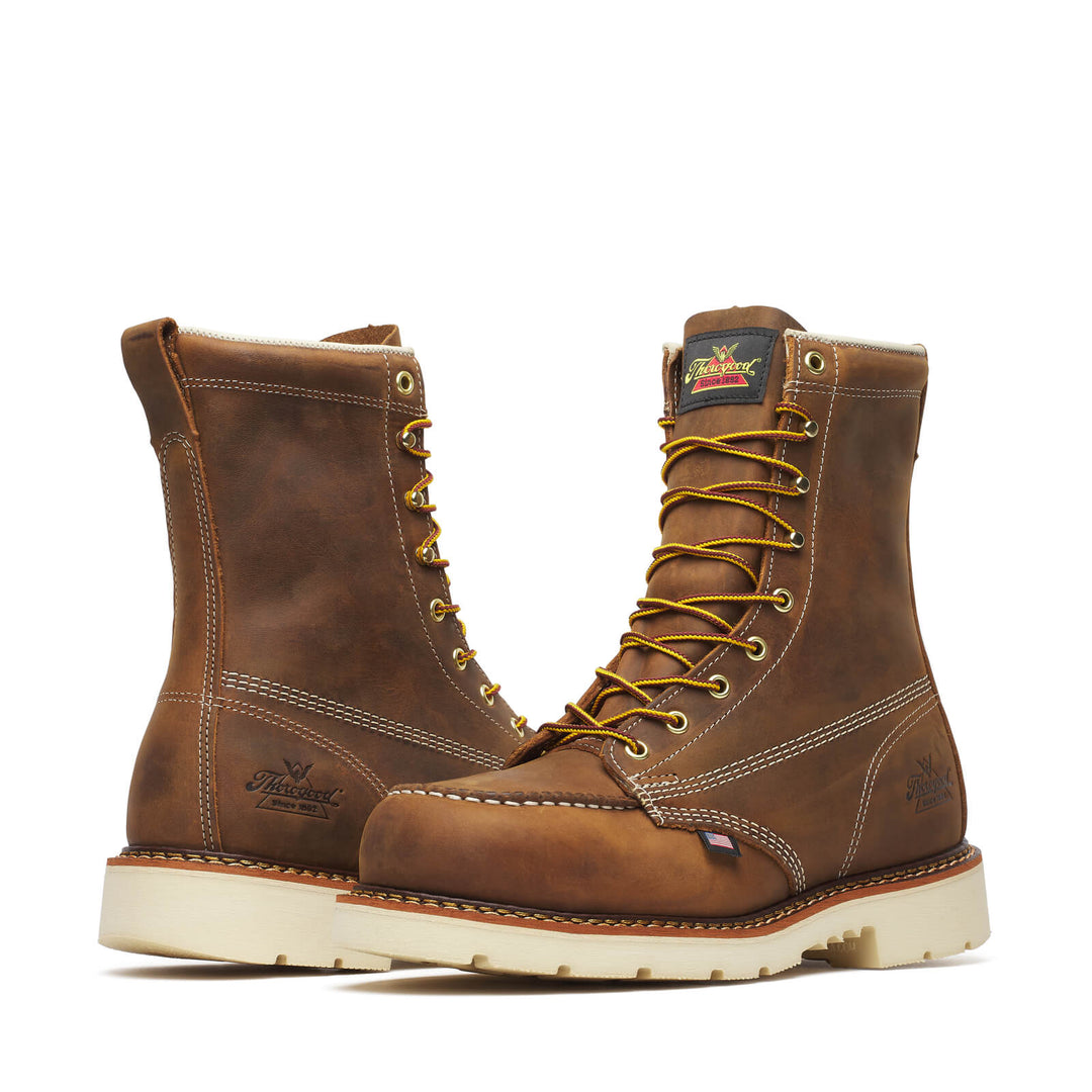 Pair of brown leather boots with yellow laces on a white background