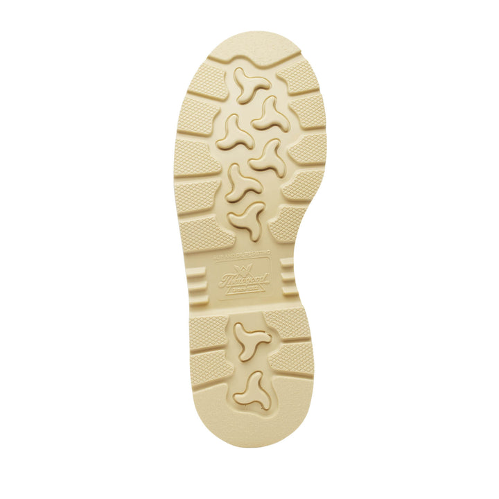 Beige sole of a shoe with tread pattern on a white background