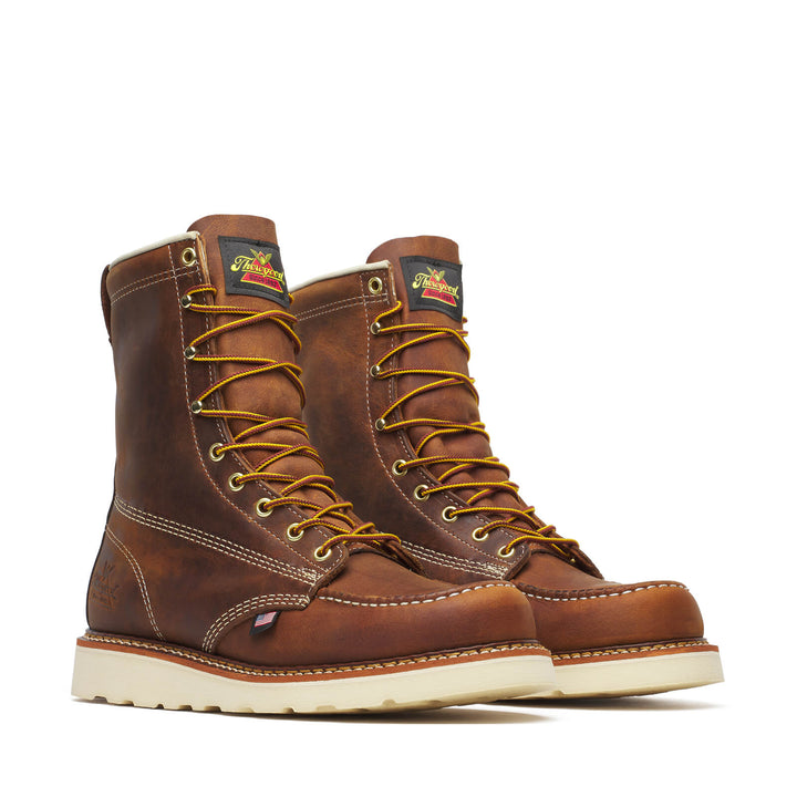 Pair of brown leather boots with yellow laces on a white background