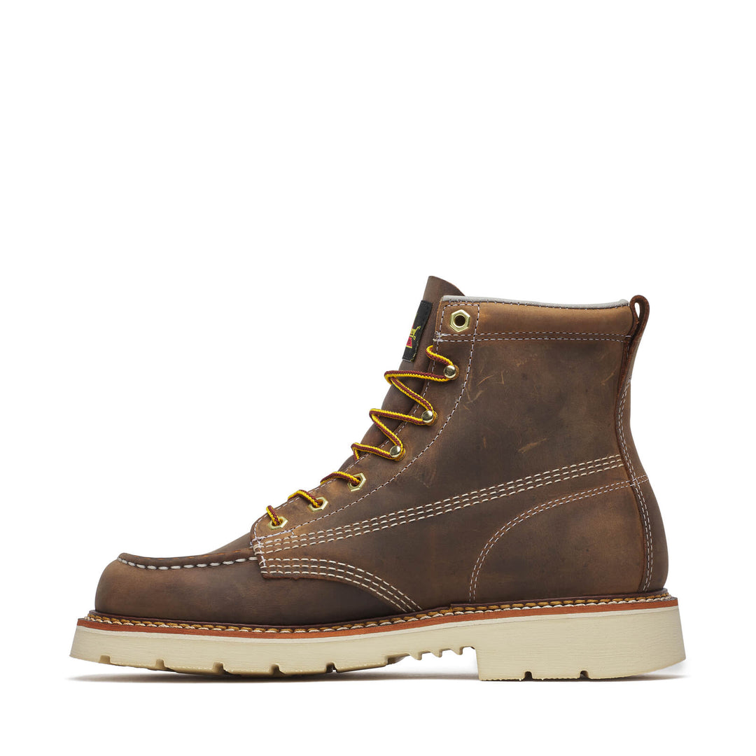 Brown leather boot with gold laces on a white background