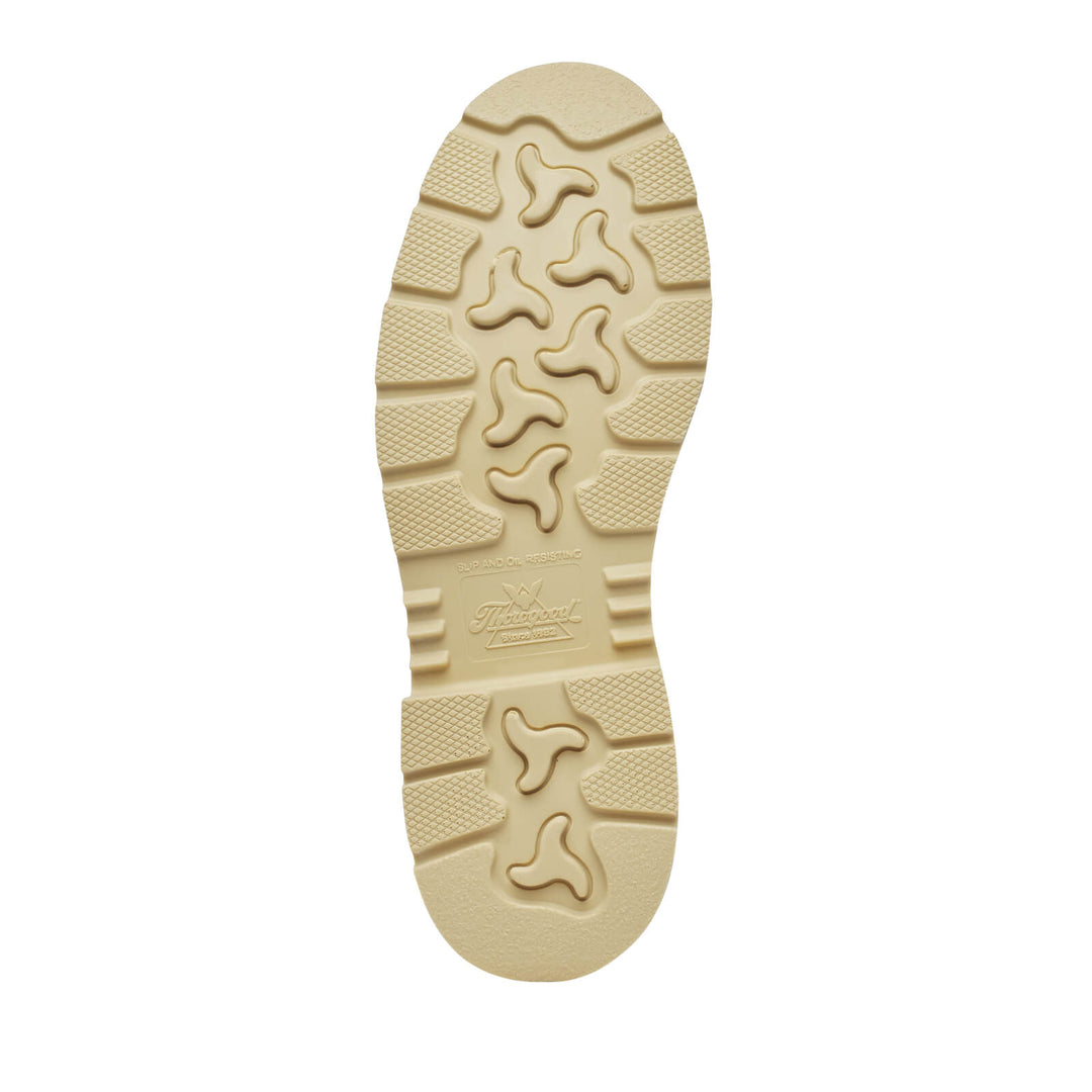 Beige sole of a shoe with tread pattern on a white background