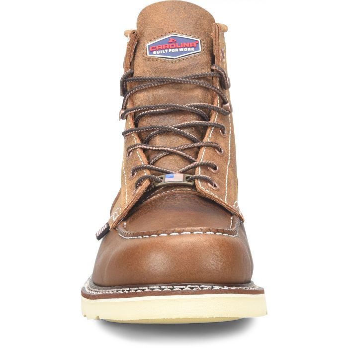 A tan boot with brown laces on a white background. 