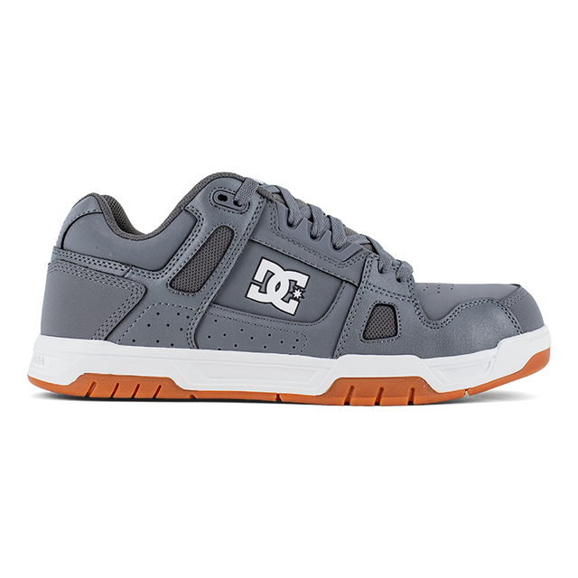 Gray sneaker with orange sole on a white background