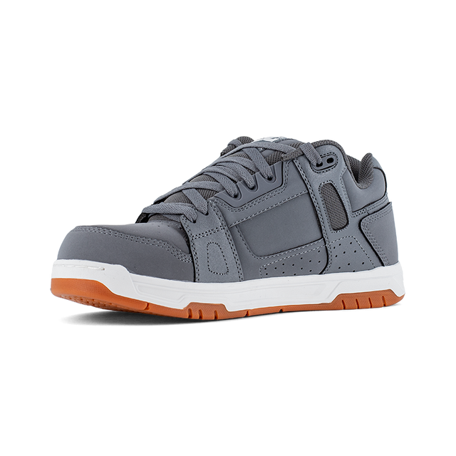 Gray sneaker with orange sole on a white background