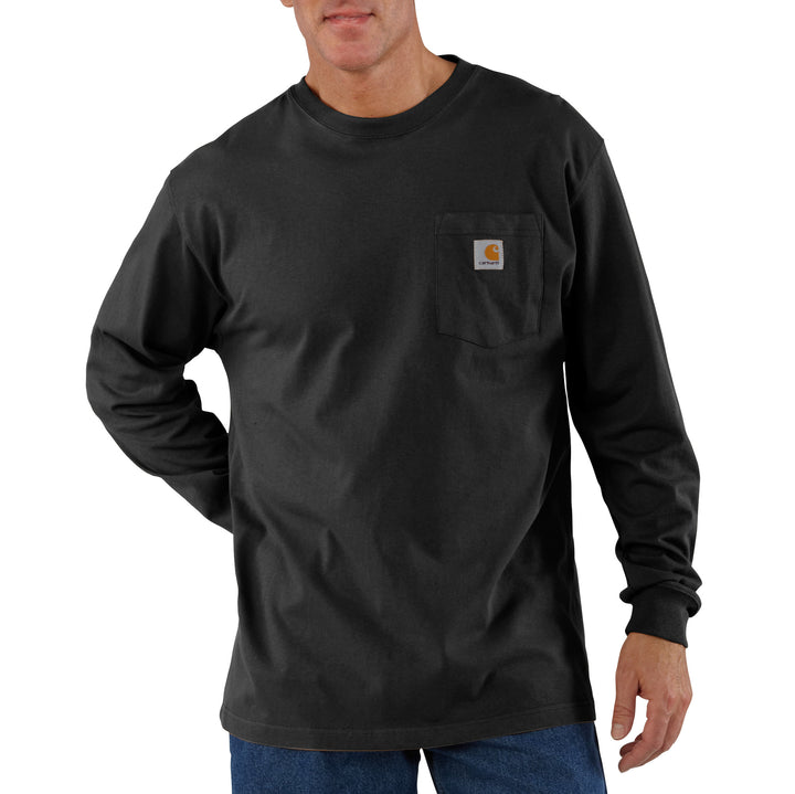A man wearing a long-sleeve black t-shirt with a front chest pocket and the Carhartt logo on the patch.