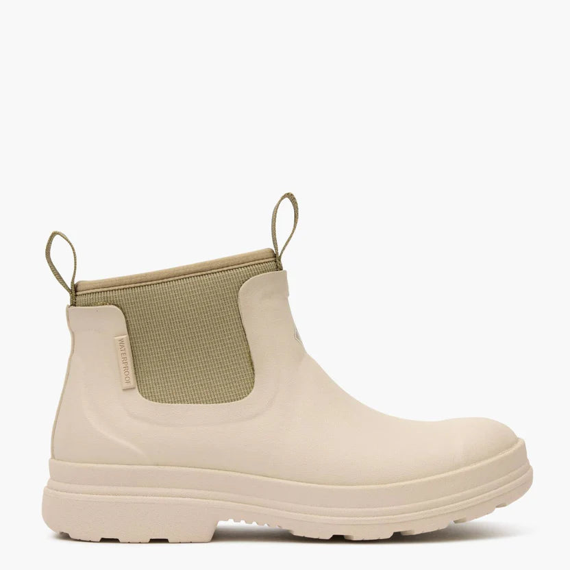 Beige rubber boot with green patch on a white background
