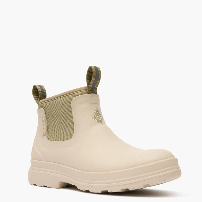 Beige rubber boot with green accents on a white background