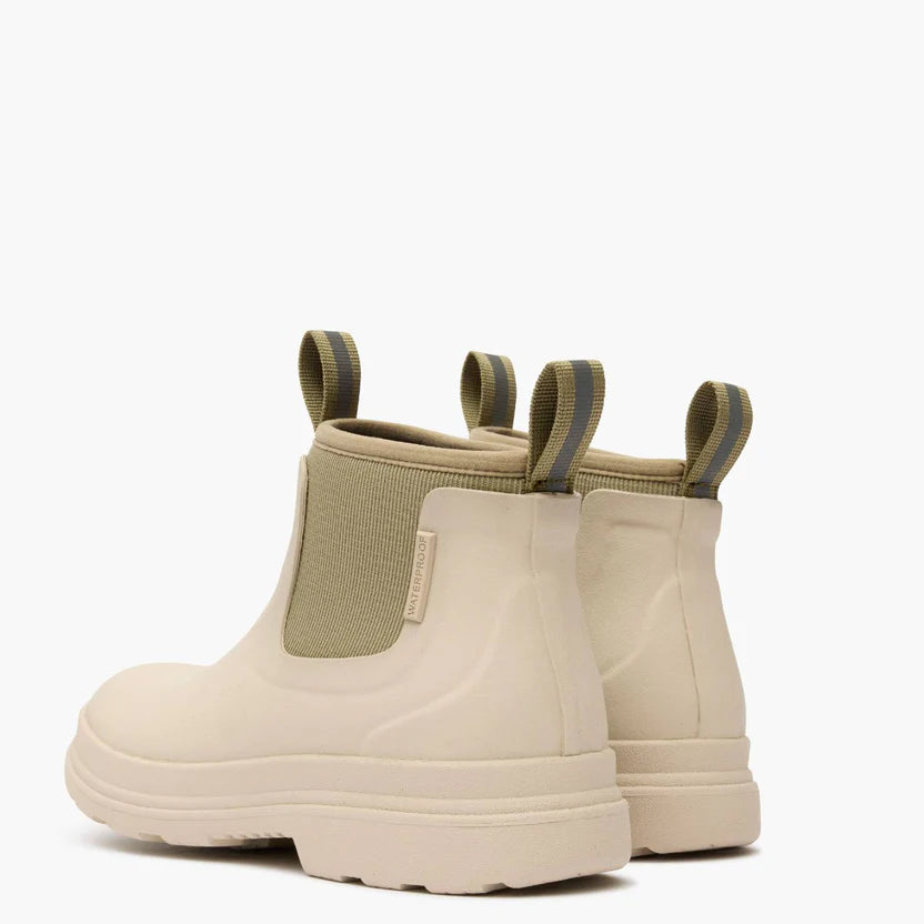 Pair of beige rubber boots with elastic sides on a white background